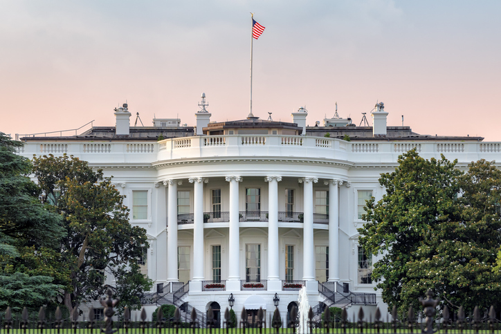 The White House in Washington DC with american flag on sunset sky at summer sunset